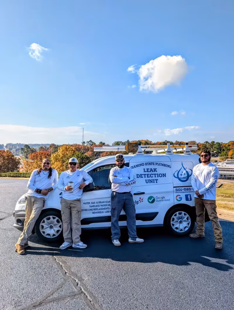 Diamond State Plumbing crew posing with branded company vehicle