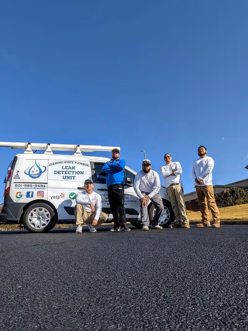 Diamond State Plumbing crew posing with branded company vehicle