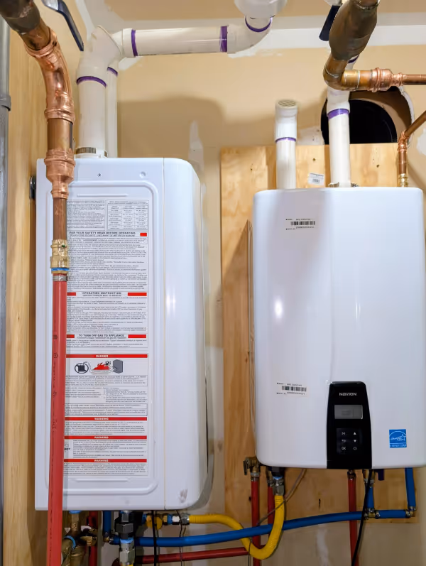 Two Navien tankless water heaters installed on a wall