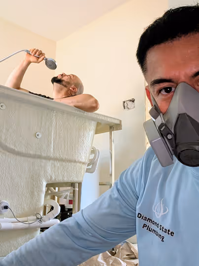 Diamond State Plumbing technicians positioning a bathtub during installation