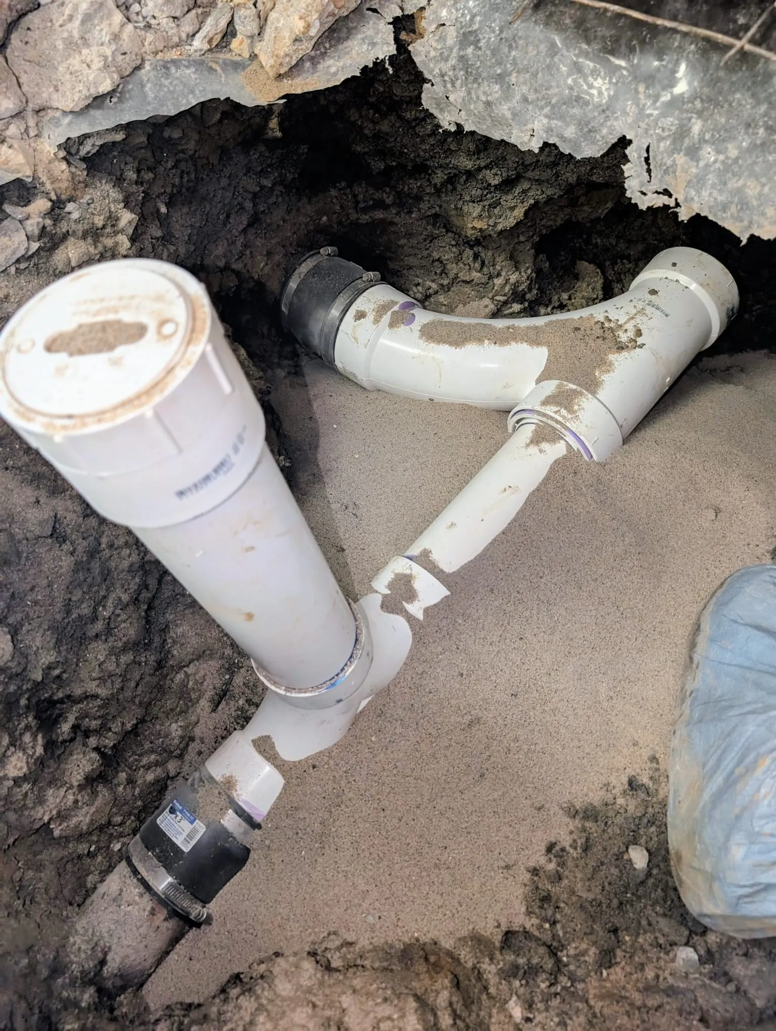 Two-way sewer clean-out installed outside a building near UALR, giving direct access to the main line