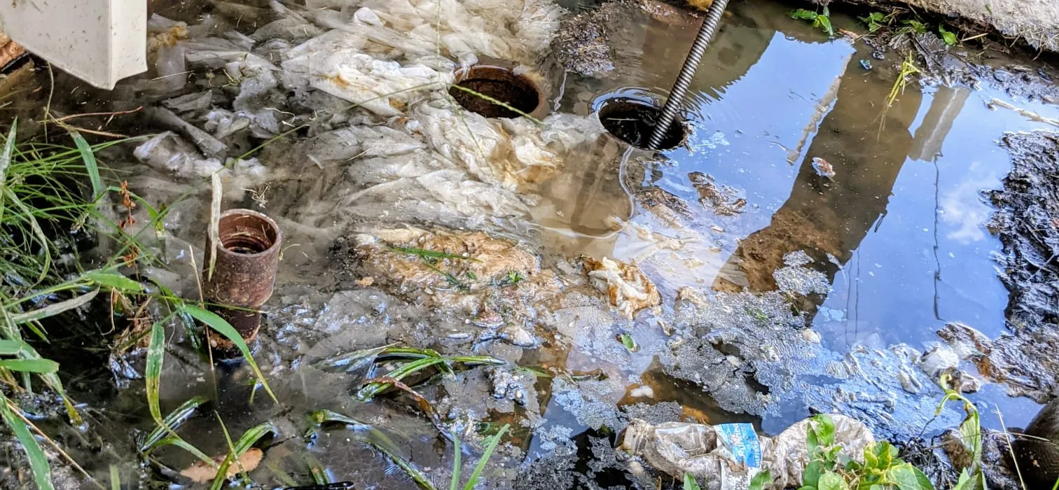 Excavated trench with old and new water service lines