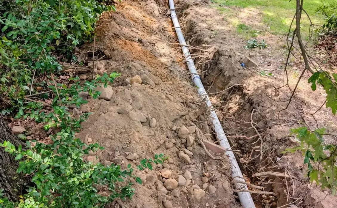 Excavated trench with old and new water service lines