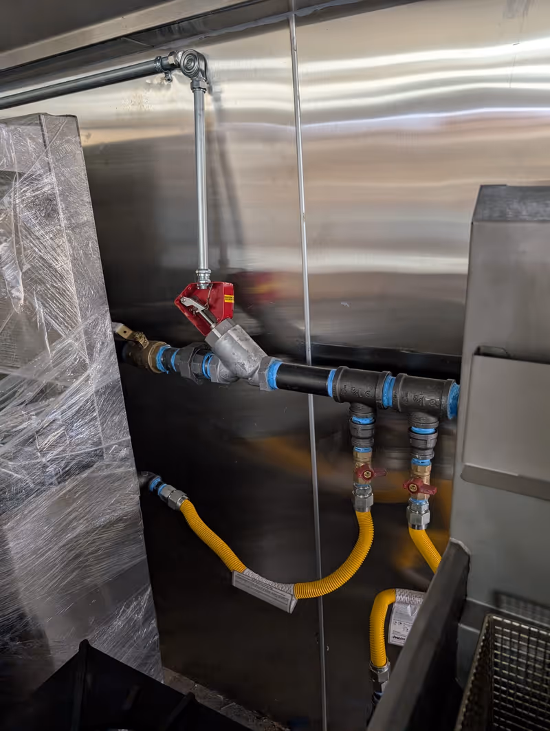 Fire suppression gas valves installed to supply kitchen equipment in a commercial building