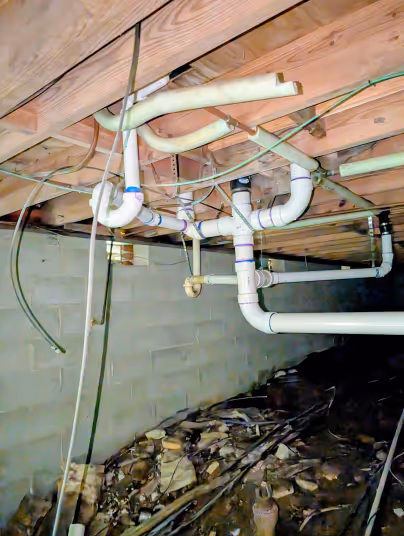 PVC drain piping installed in a home's crawl space
