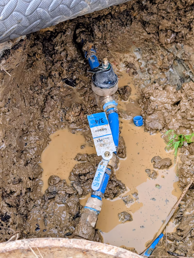Plumber repairing a pipe leak in a west Little Rock home