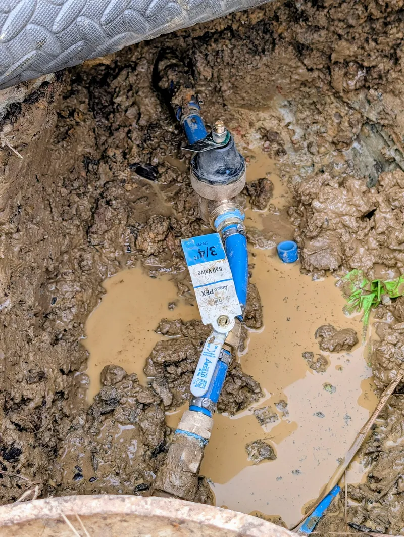 Plumber repairing a pipe leak in a west Little Rock home