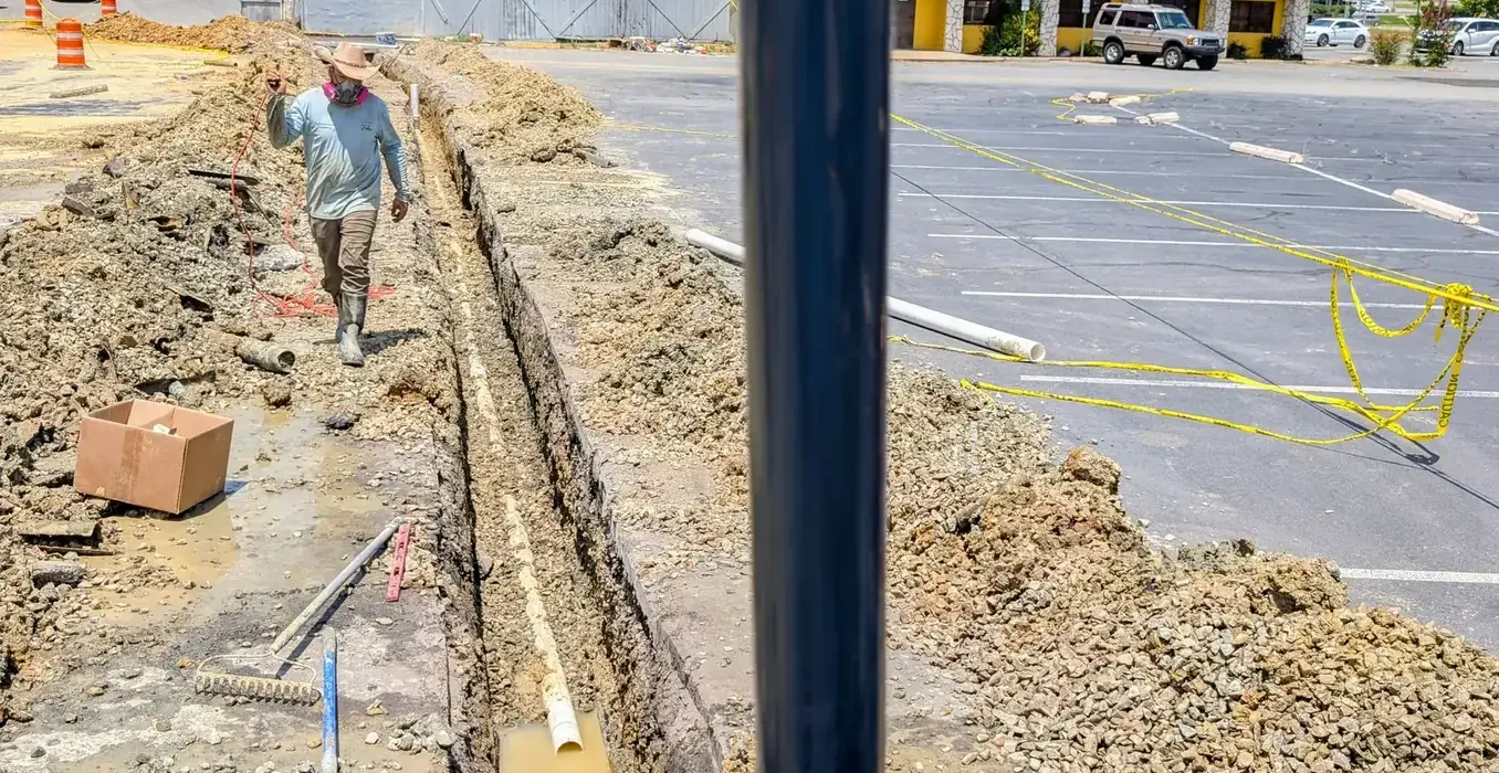 Excavated trench with old and new water service lines