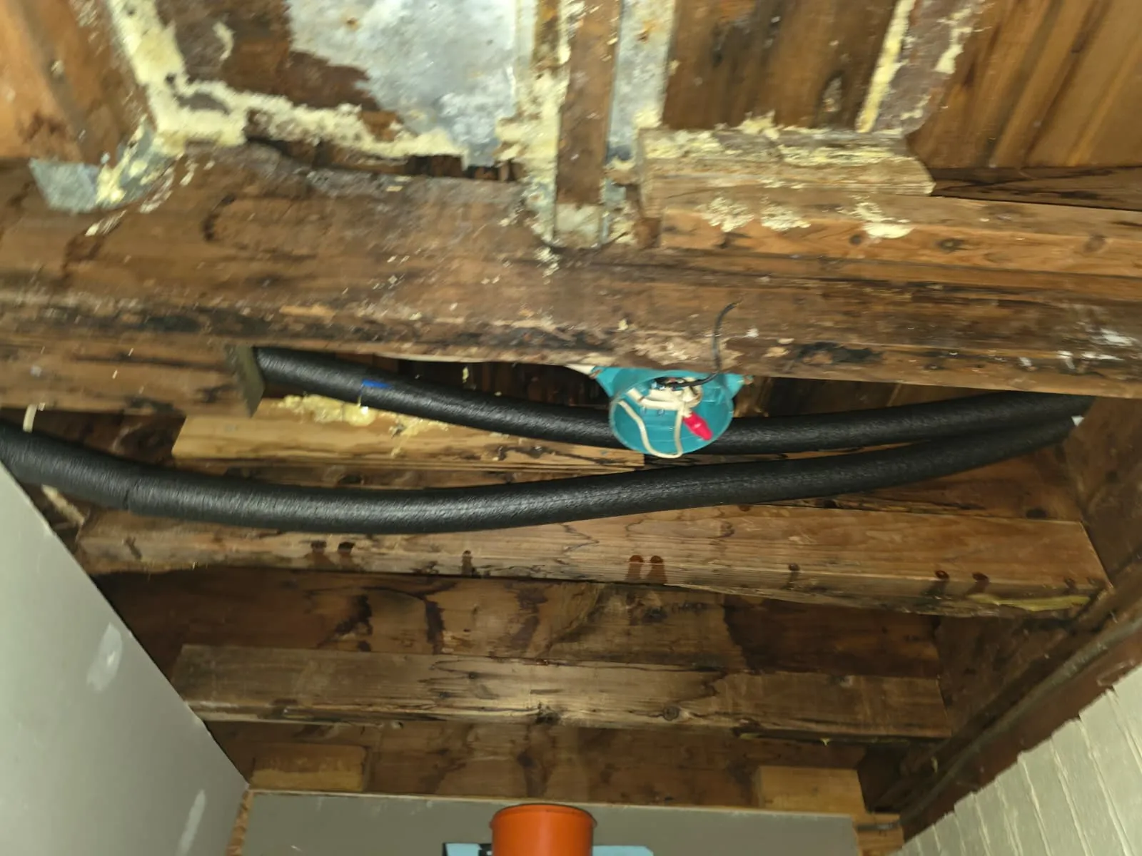 Insulated PEX water lines routed under a floor during a Little Rock repipe