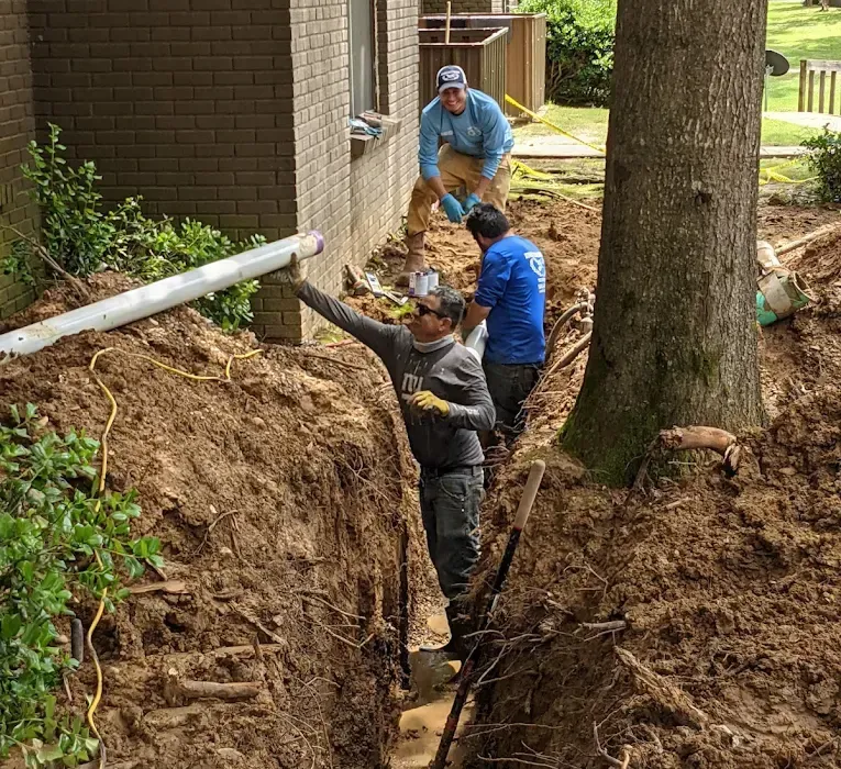 Excavated trench with old and new water service lines