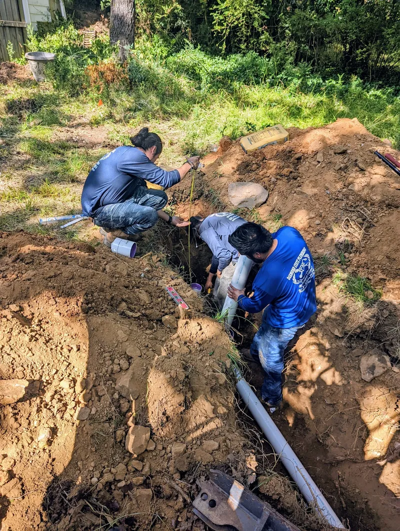 Diamond State Plumbing crew installing new sewer line in a Cammack Village yard