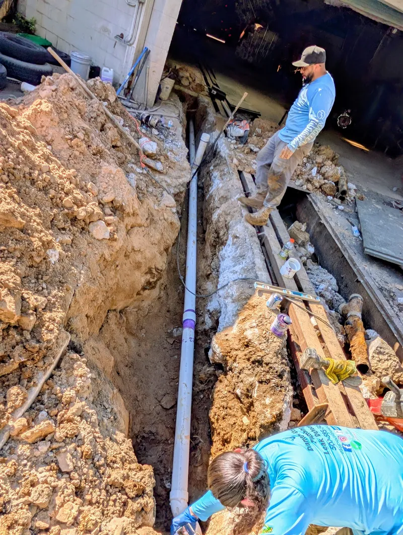 New sewer line installed in a deep trench at a commercial property to reroute the drain system and abandon the old car wash drain