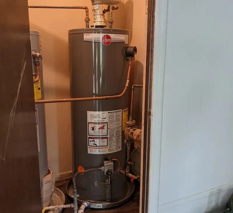 Stiebel Eltron point-of-use tankless water heater with insulated pipe connections mounted on a wall