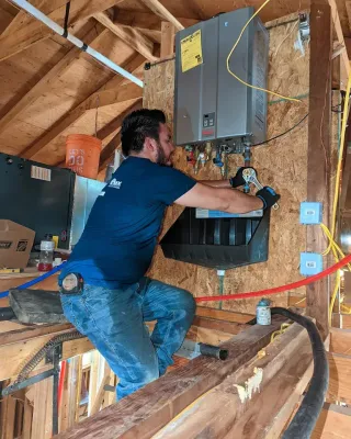 Diamond State Plumbing crew member adjusting water heater connections with wrench