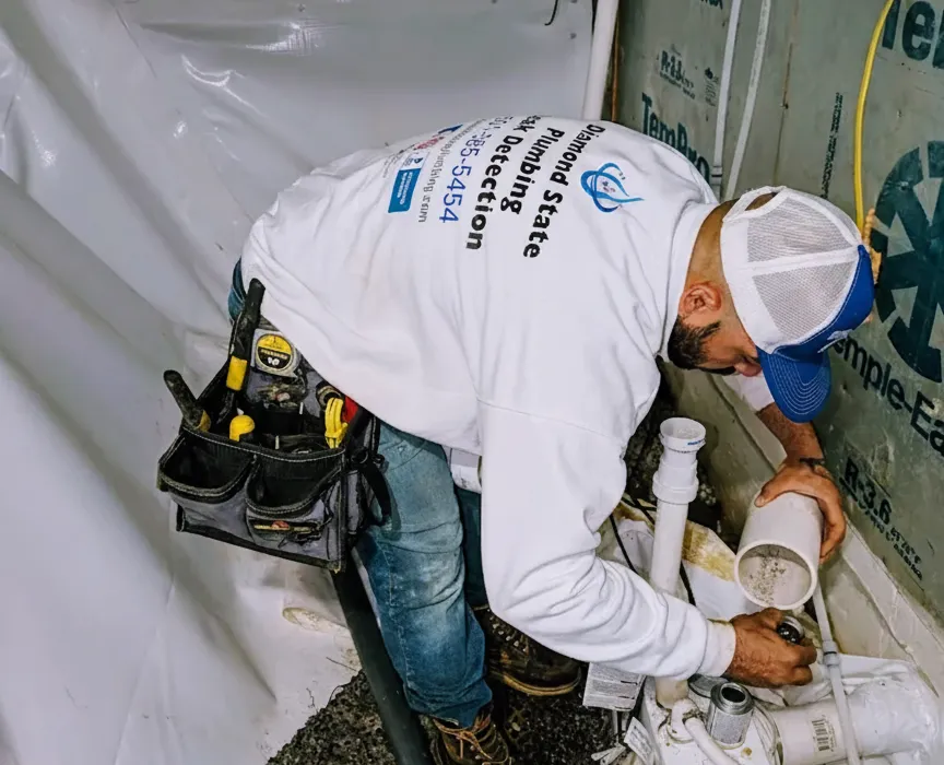 Diamond State Plumbing technician installing drain pipes for a toilet rough-in