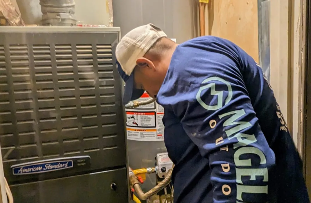 Stiebel Eltron point-of-use tankless water heater with insulated pipe connections mounted on a wall