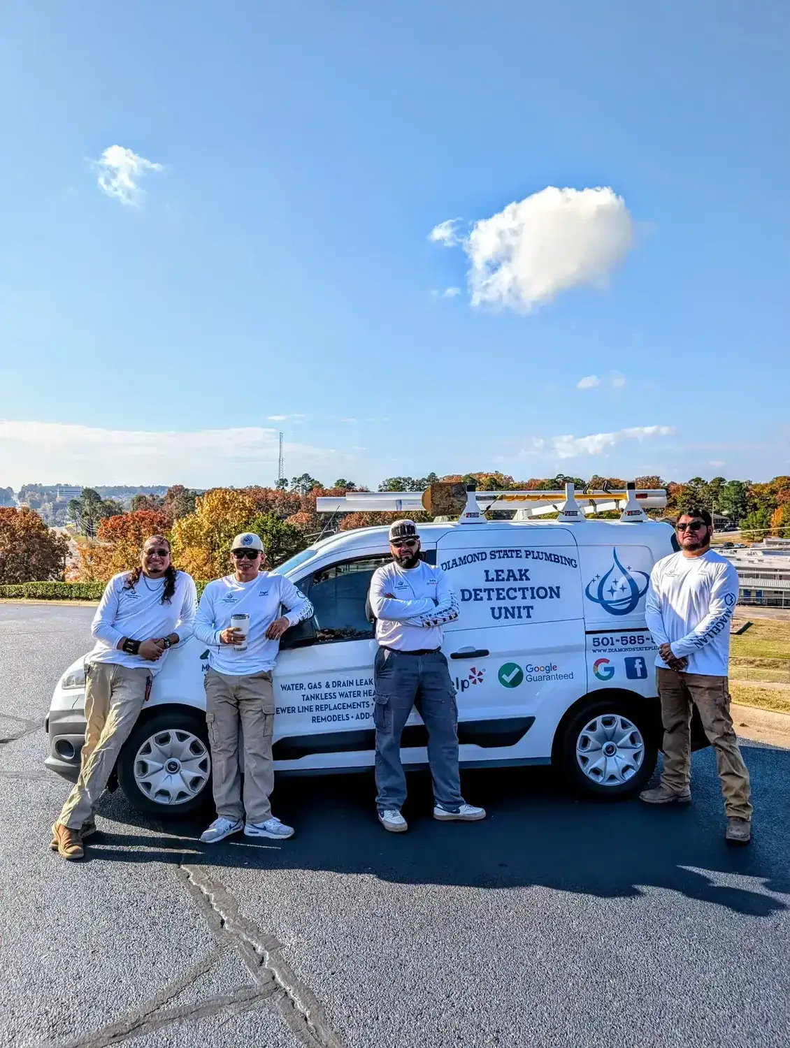 Diamond State Plumbing crew posing with branded company vehicle