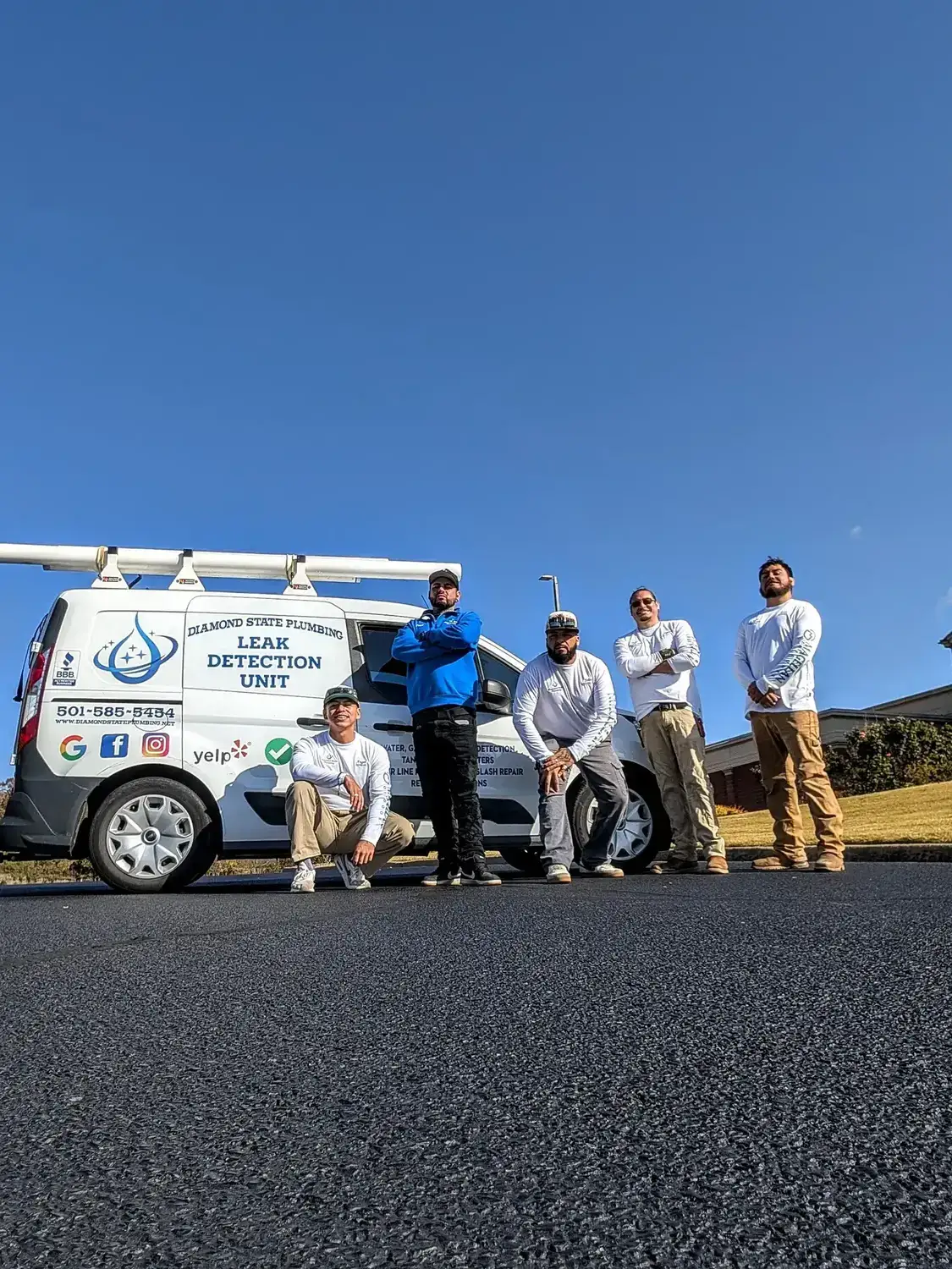 Diamond State Plumbing crew posing with branded company vehicle